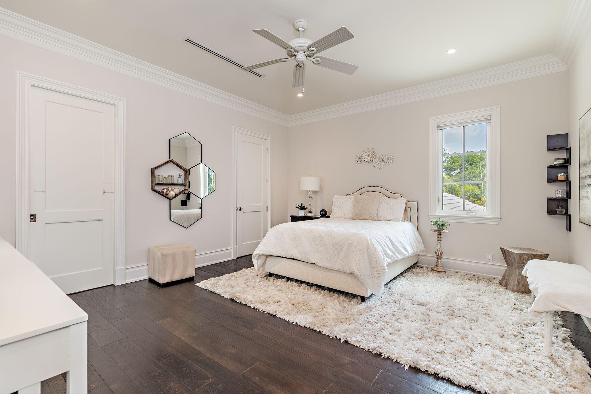1222 North Ocean Boulevard Gulf Stream, FL 33483 - Photo 19 of 61 a bedroom with a large bed and a chandelier