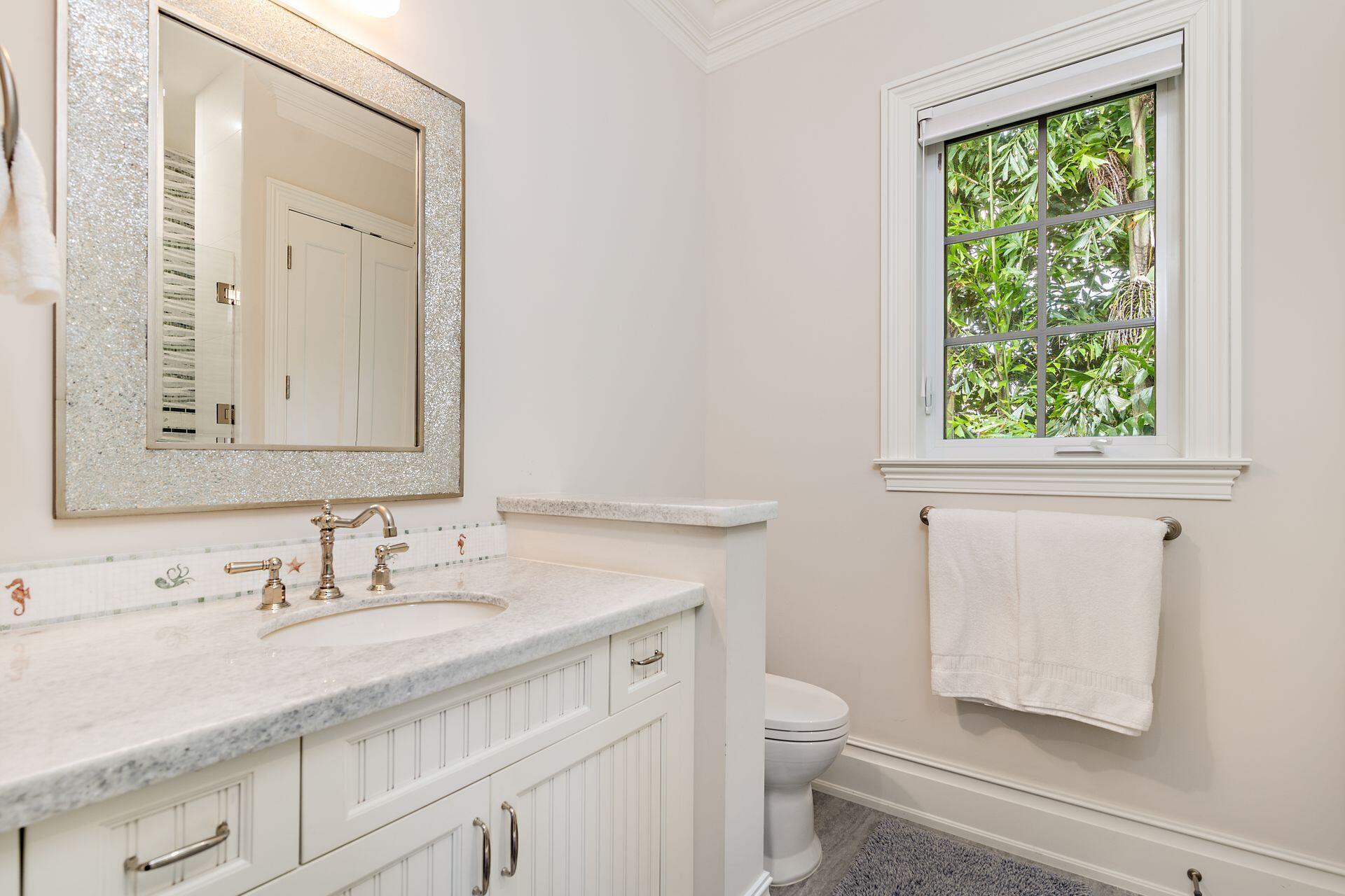 1222 North Ocean Boulevard Gulf Stream, FL 33483 - Photo 20 of 61 a bathroom with a granite countertop sink a toilet and a window