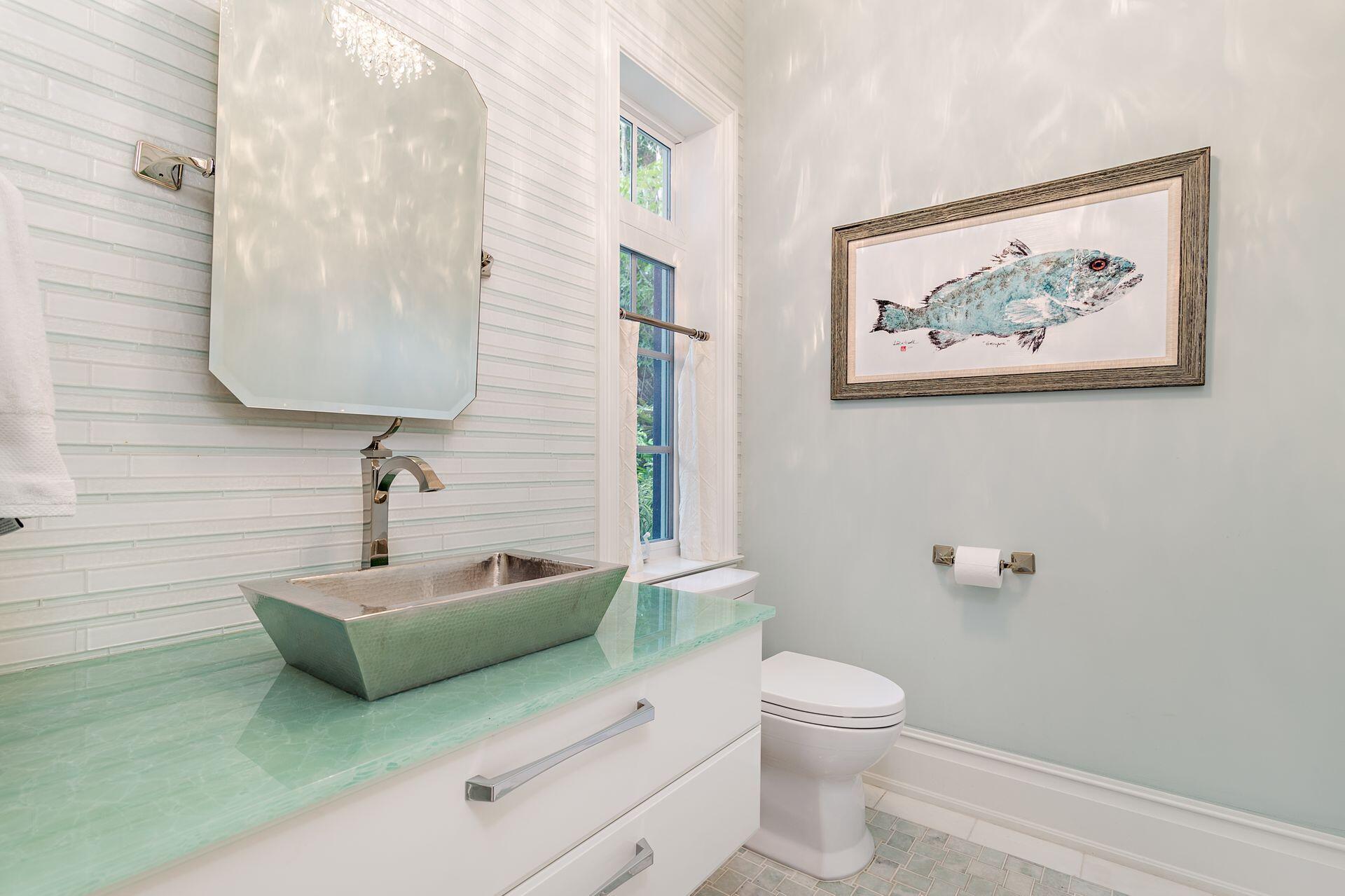 1222 North Ocean Boulevard Gulf Stream, FL 33483 - Photo 23 of 61 a bathroom with a toilet a sink and mirror