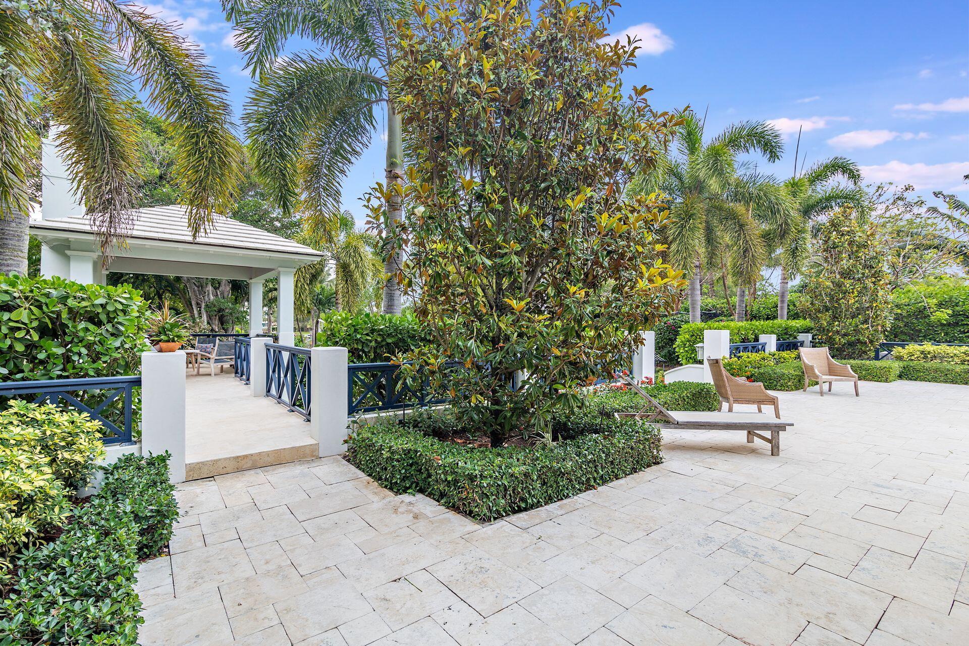 1222 North Ocean Boulevard Gulf Stream, FL 33483 - Photo 50 of 61 a view of a patio with couches table and chairs and potted plants