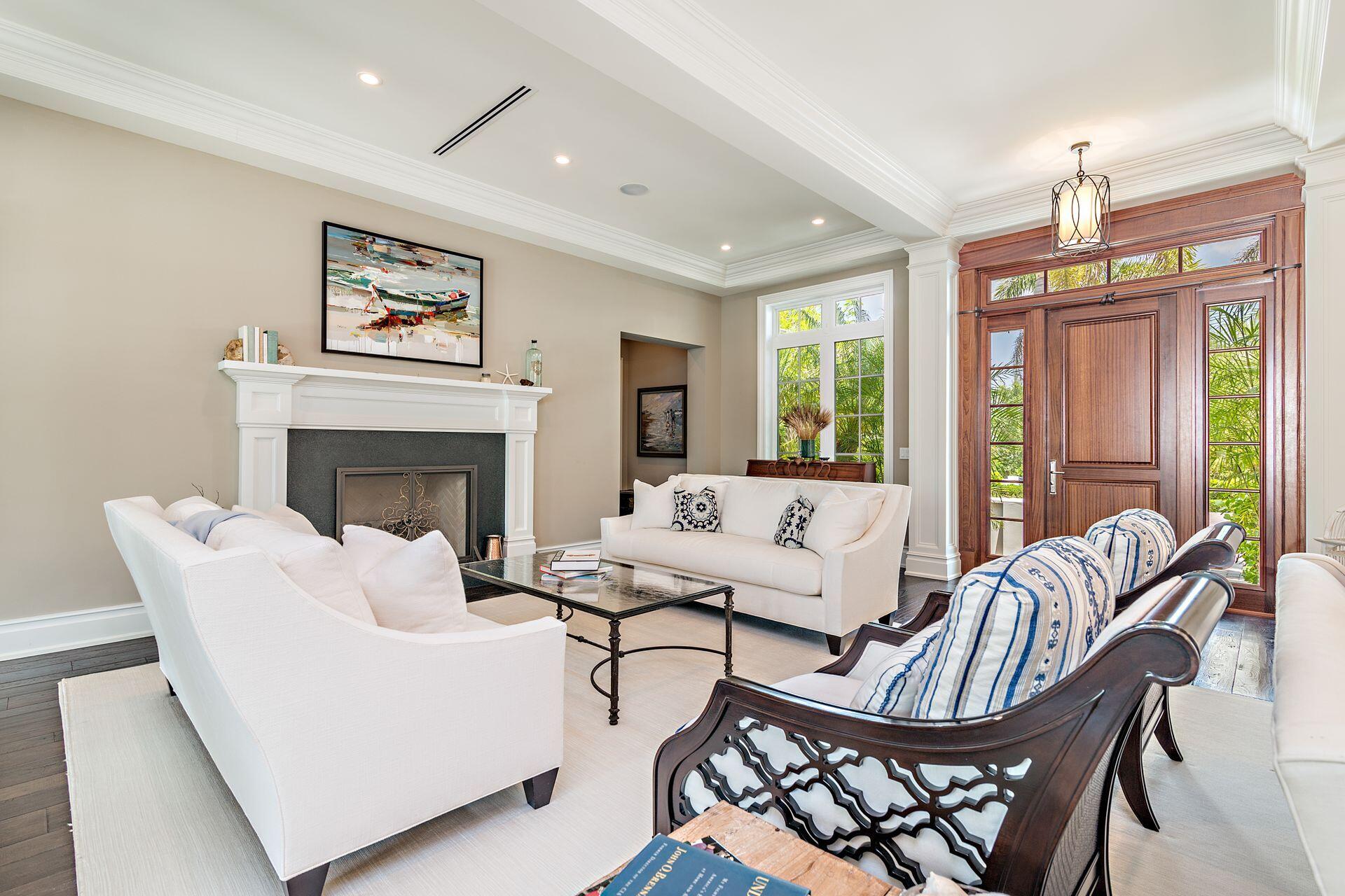 1222 North Ocean Boulevard Gulf Stream, FL 33483 - Photo 5 of 61 a living room with furniture a large window and a fireplace