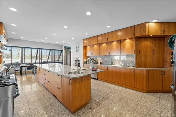 a kitchen with stainless steel appliances granite countertop a sink and cabinets
