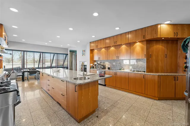 a kitchen with stainless steel appliances granite countertop a sink and cabinets