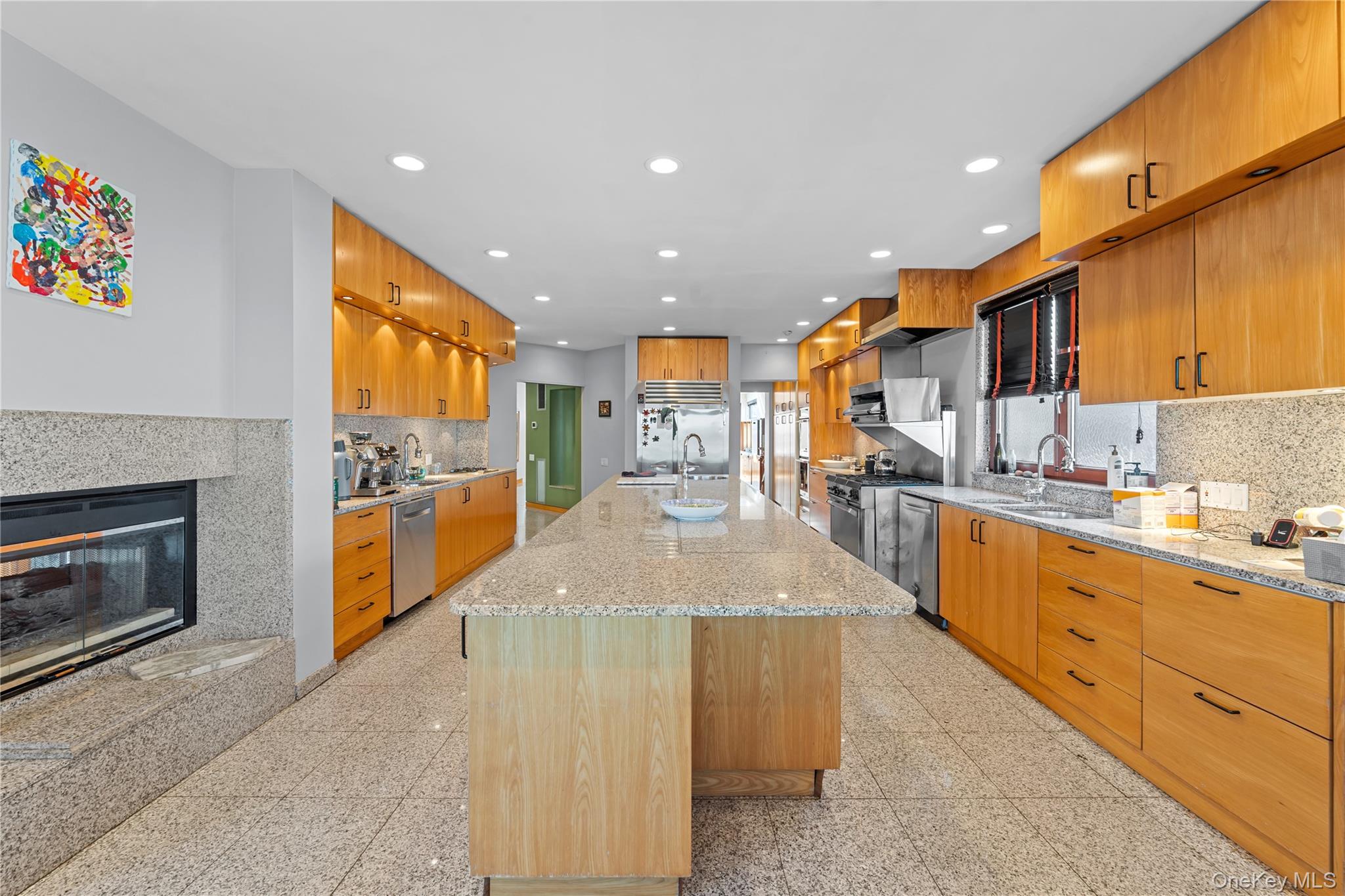 2829 Frankel Boulevard Merrick, NY 11566 - Photo 12 of 46 a large kitchen with stainless steel appliances kitchen island granite countertop a large counter top cabinets and a couch