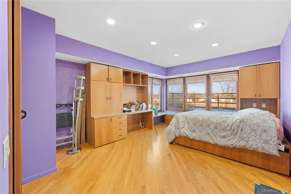 a spacious bedroom with a large bed and a dresser