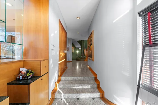 a view of entryway and hall with wooden floor