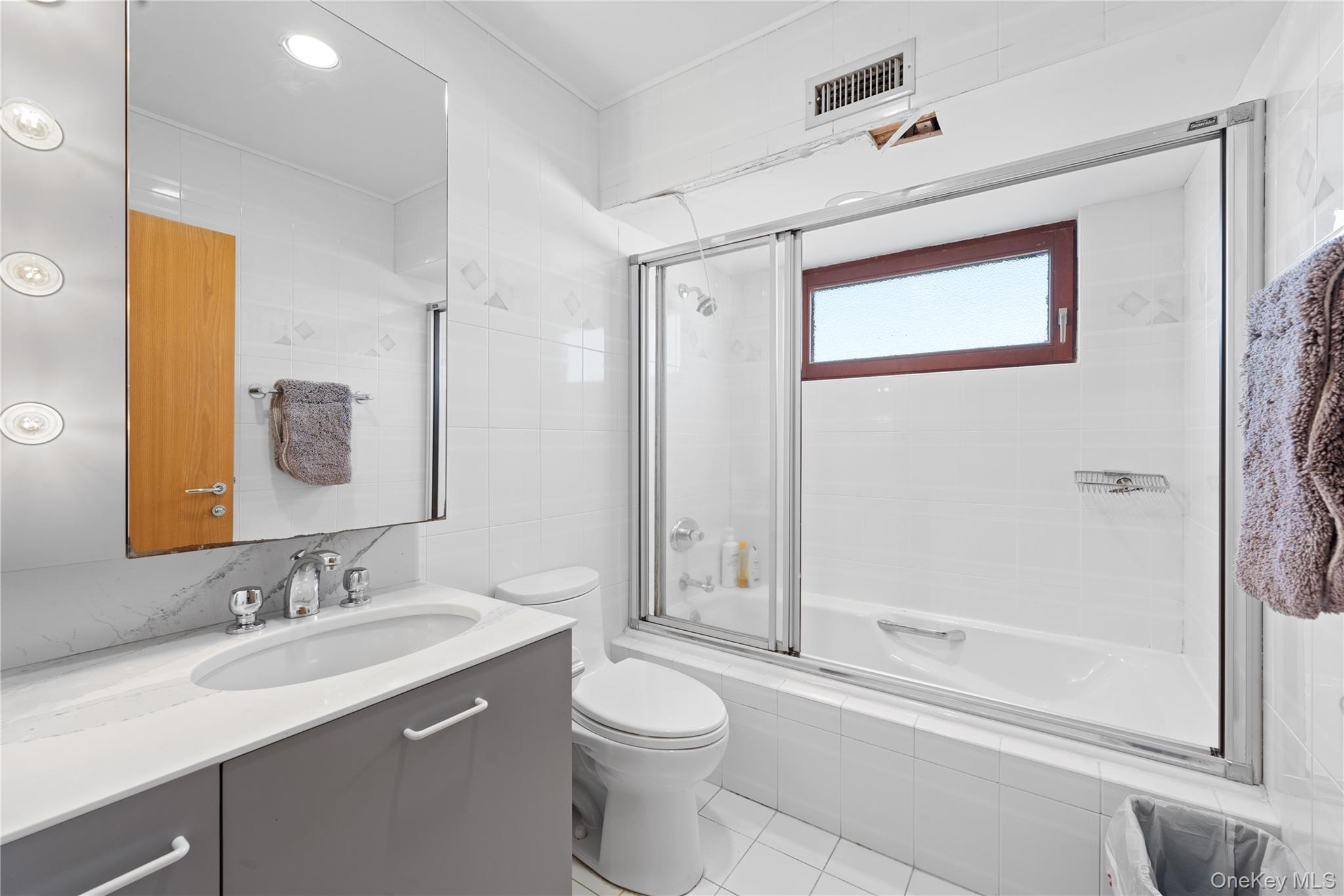 2829 Frankel Boulevard Merrick, NY 11566 - Photo 21 of 46 a bathroom with a granite countertop sink toilet and shower