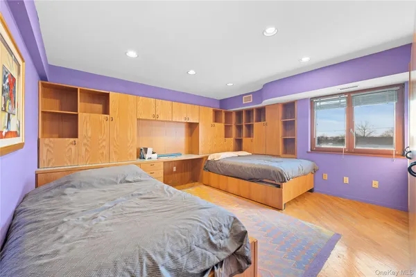a spacious bedroom with a bed and large windows