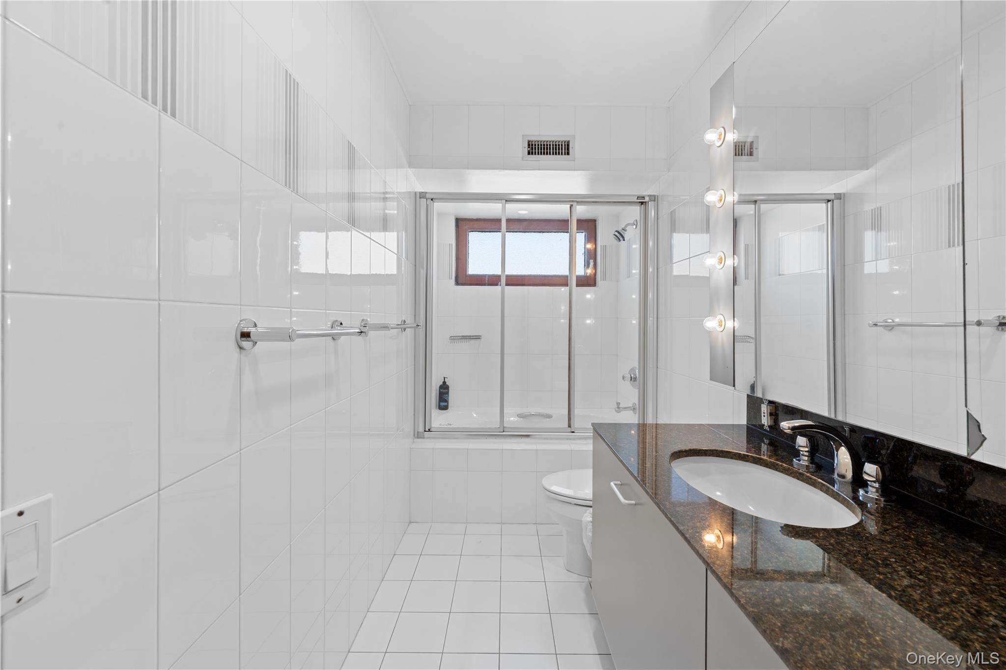 2829 Frankel Boulevard Merrick, NY 11566 - Photo 25 of 46 a bathroom with a granite countertop sink mirror and double