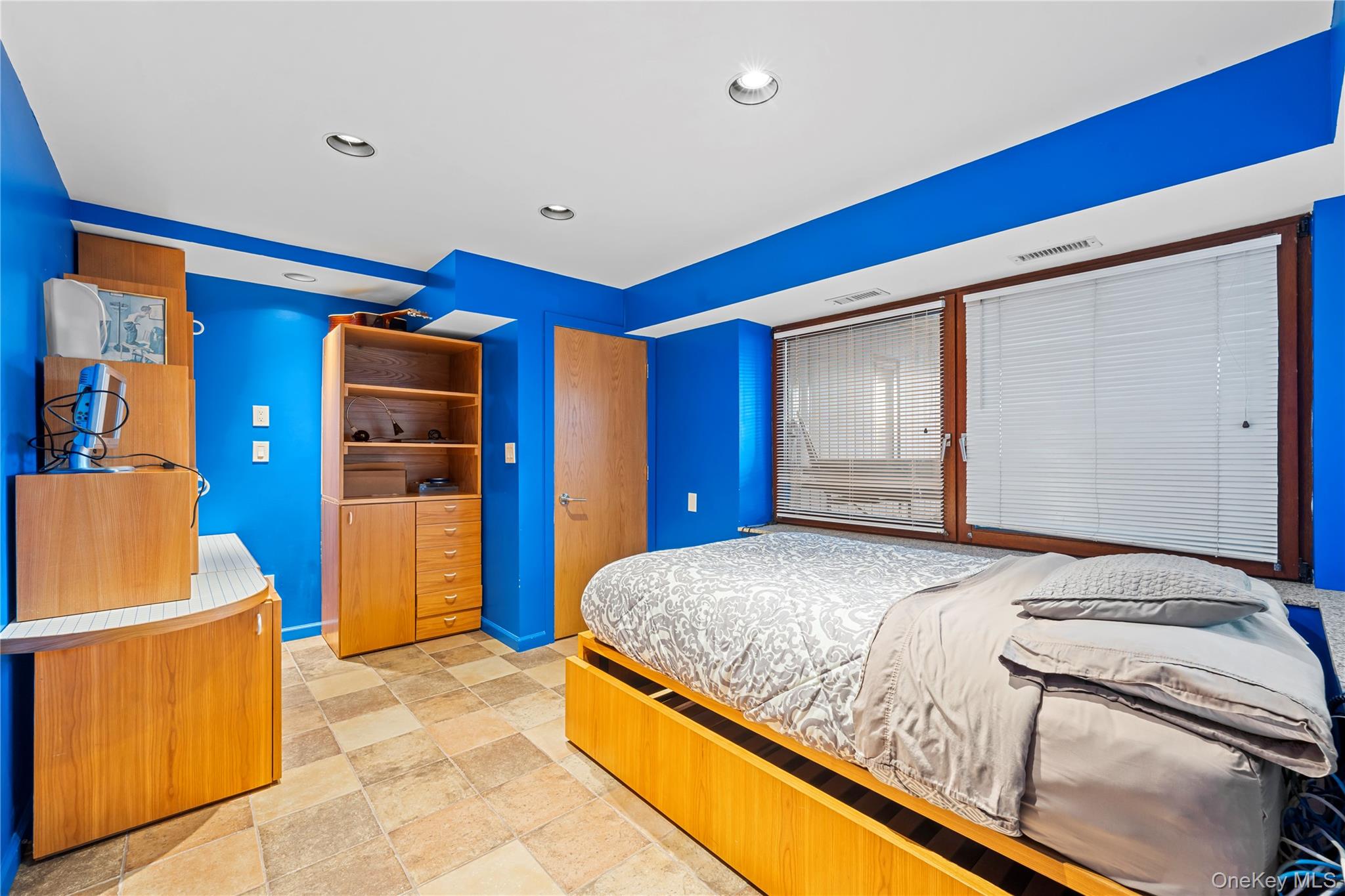 2829 Frankel Boulevard Merrick, NY 11566 - Photo 35 of 46 a bedroom with a bed and a refrigerator