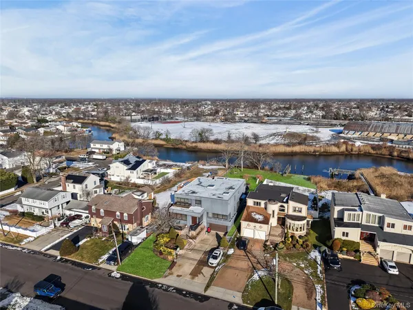 an aerial view of residential house with outdoor space and lake view