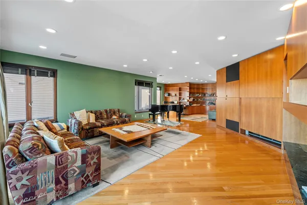 a large kitchen with stainless steel appliances kitchen island granite countertop a large counter top cabinets and a couch