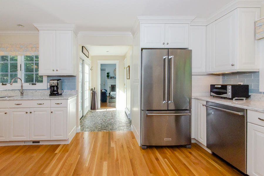 18 Register Road Marion, MA 02738 - Photo 4 of 30 a kitchen with wooden floors and stainless steel appliances