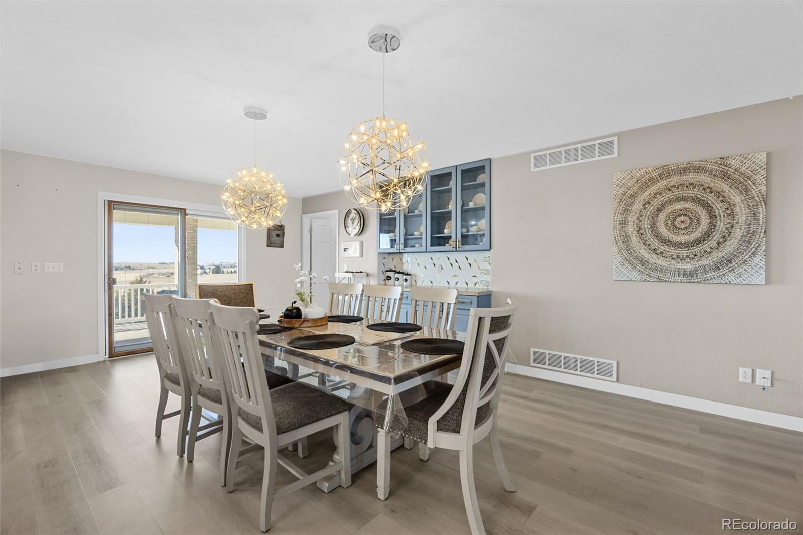 5330 Kiowa-Bennett Road Bennett, CO 80102 - Photo 16 of 50 a dining room with furniture a chandelier and wooden floor