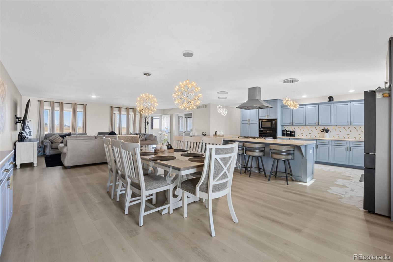 5330 Kiowa-Bennett Road Bennett, CO 80102 - Photo 18 of 50 a view of a dining room with furniture and wooden floor