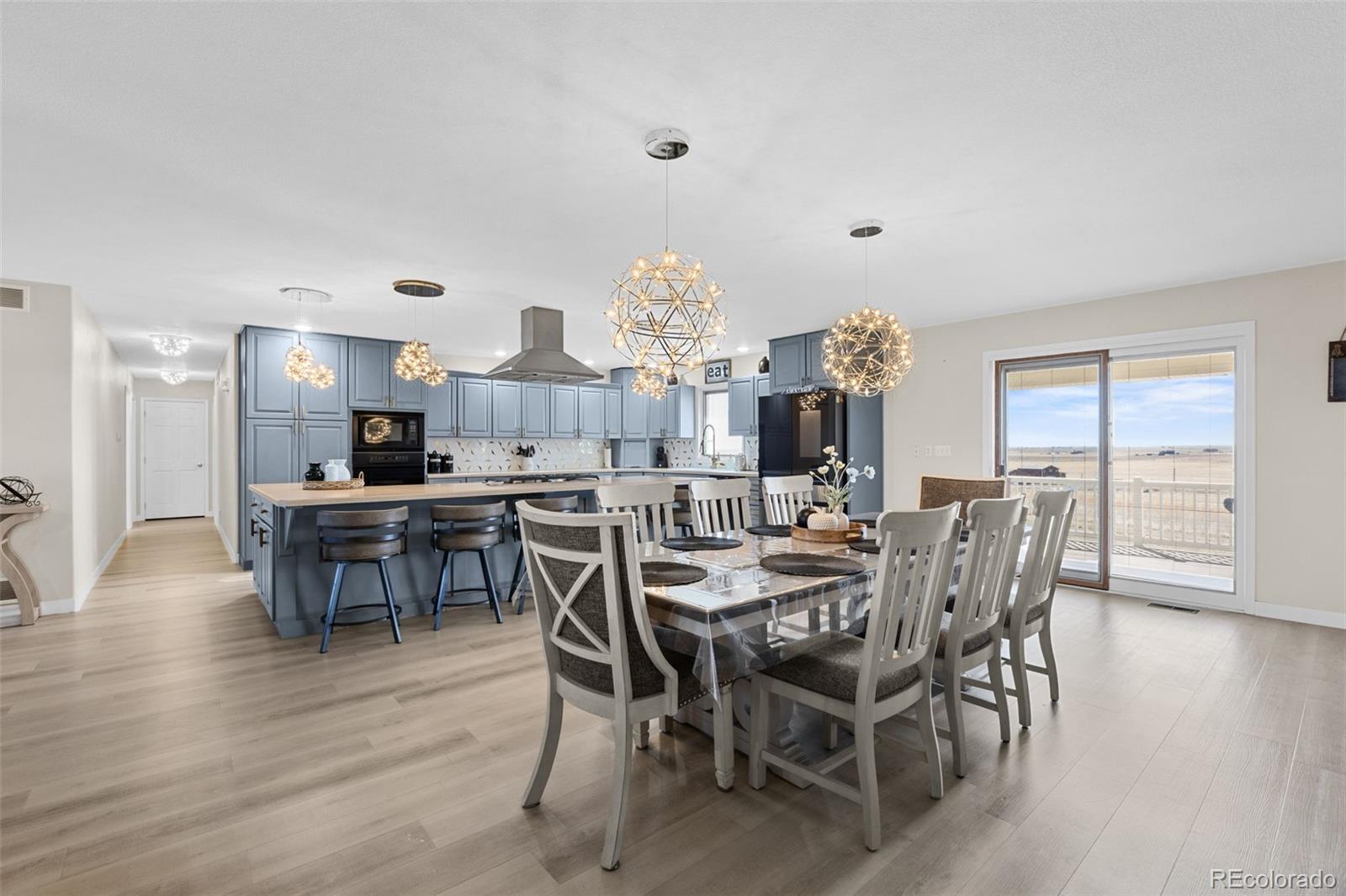 5330 Kiowa-Bennett Road Bennett, CO 80102 - Photo 19 of 50 a view of a dining room with furniture and wooden floor