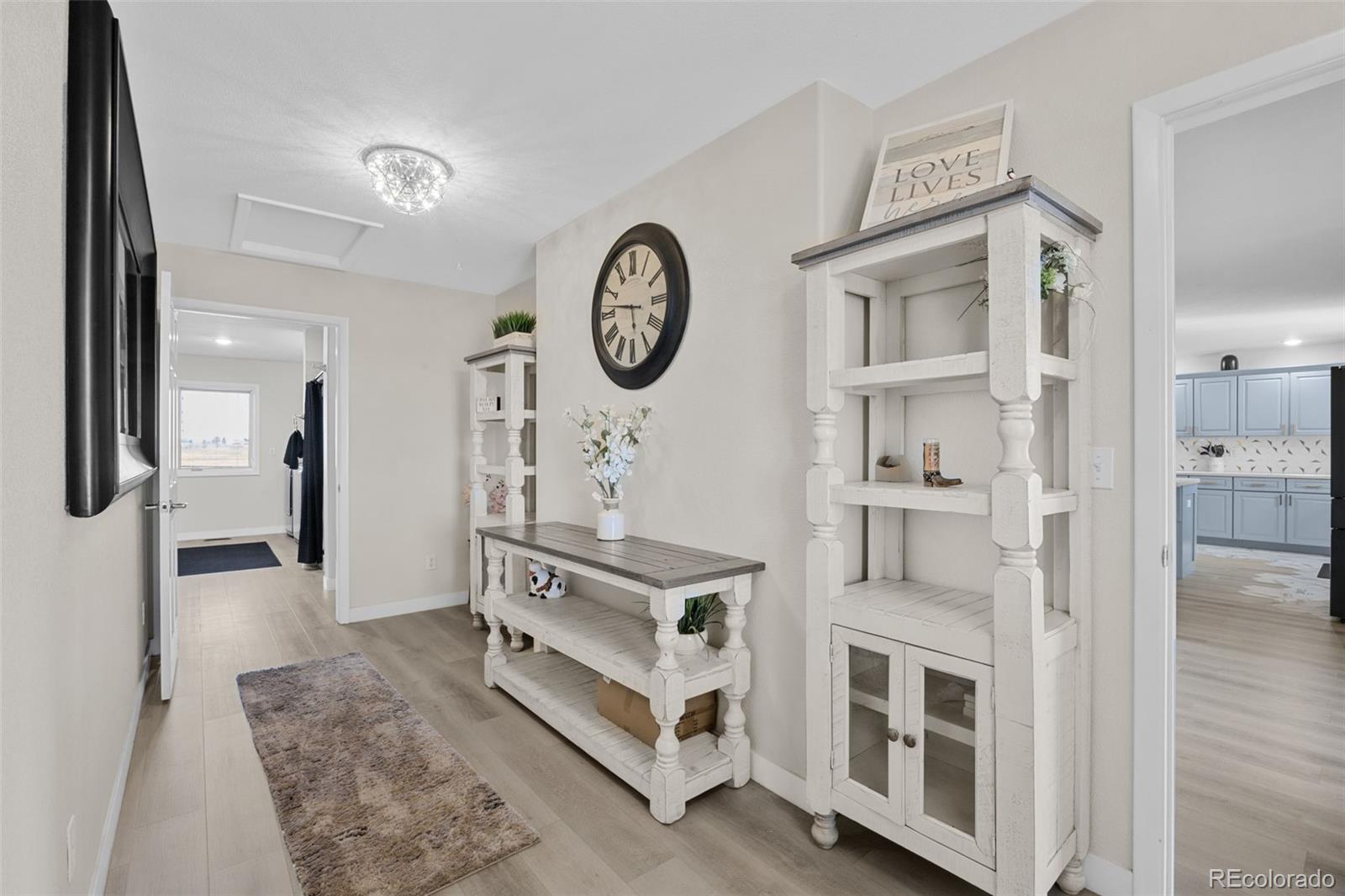 5330 Kiowa-Bennett Road Bennett, CO 80102 - Photo 29 of 50 a living room with furniture and a clock