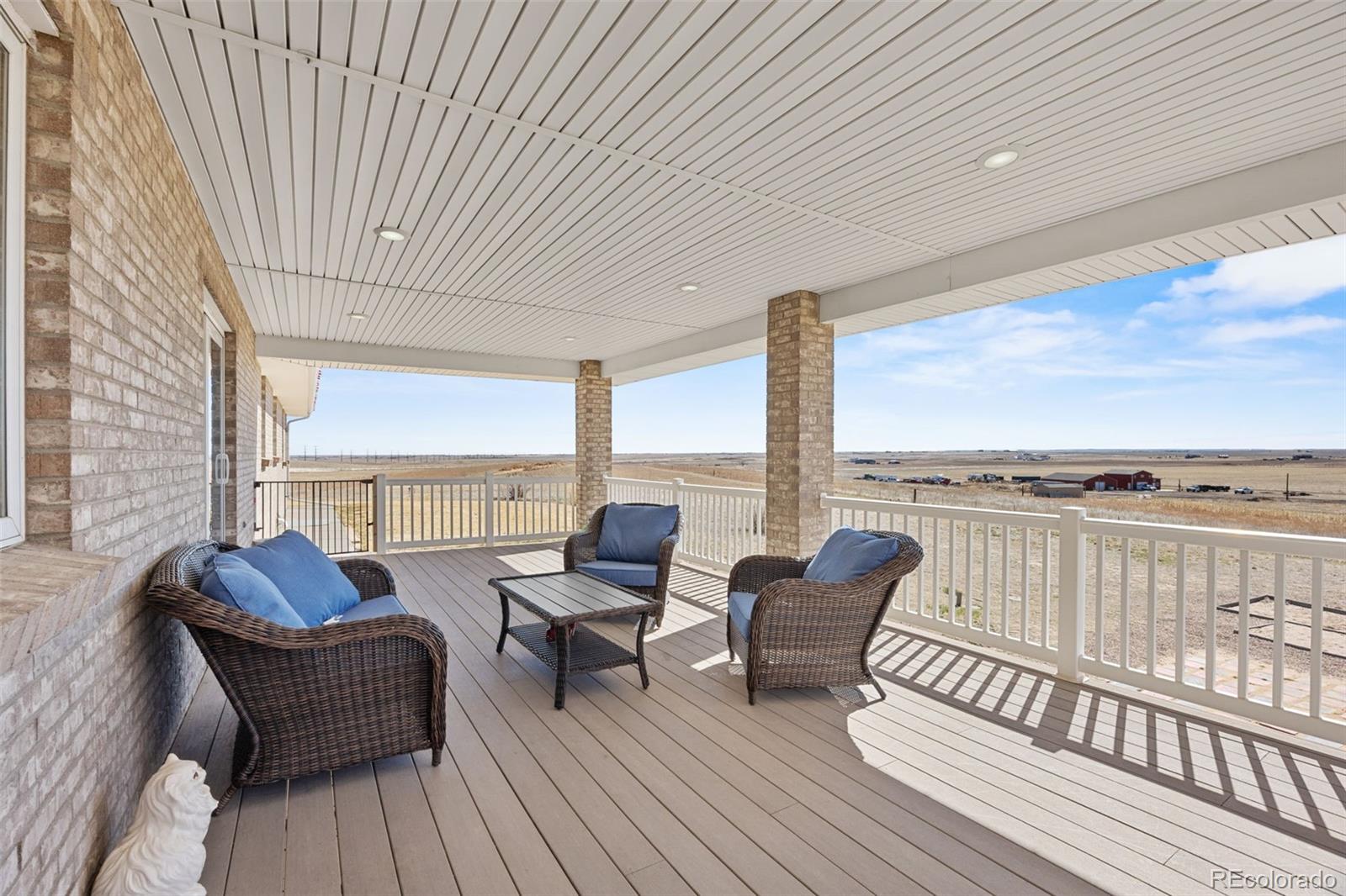 5330 Kiowa-Bennett Road Bennett, CO 80102 - Photo 31 of 50 a balcony with wooden floor and furniture
