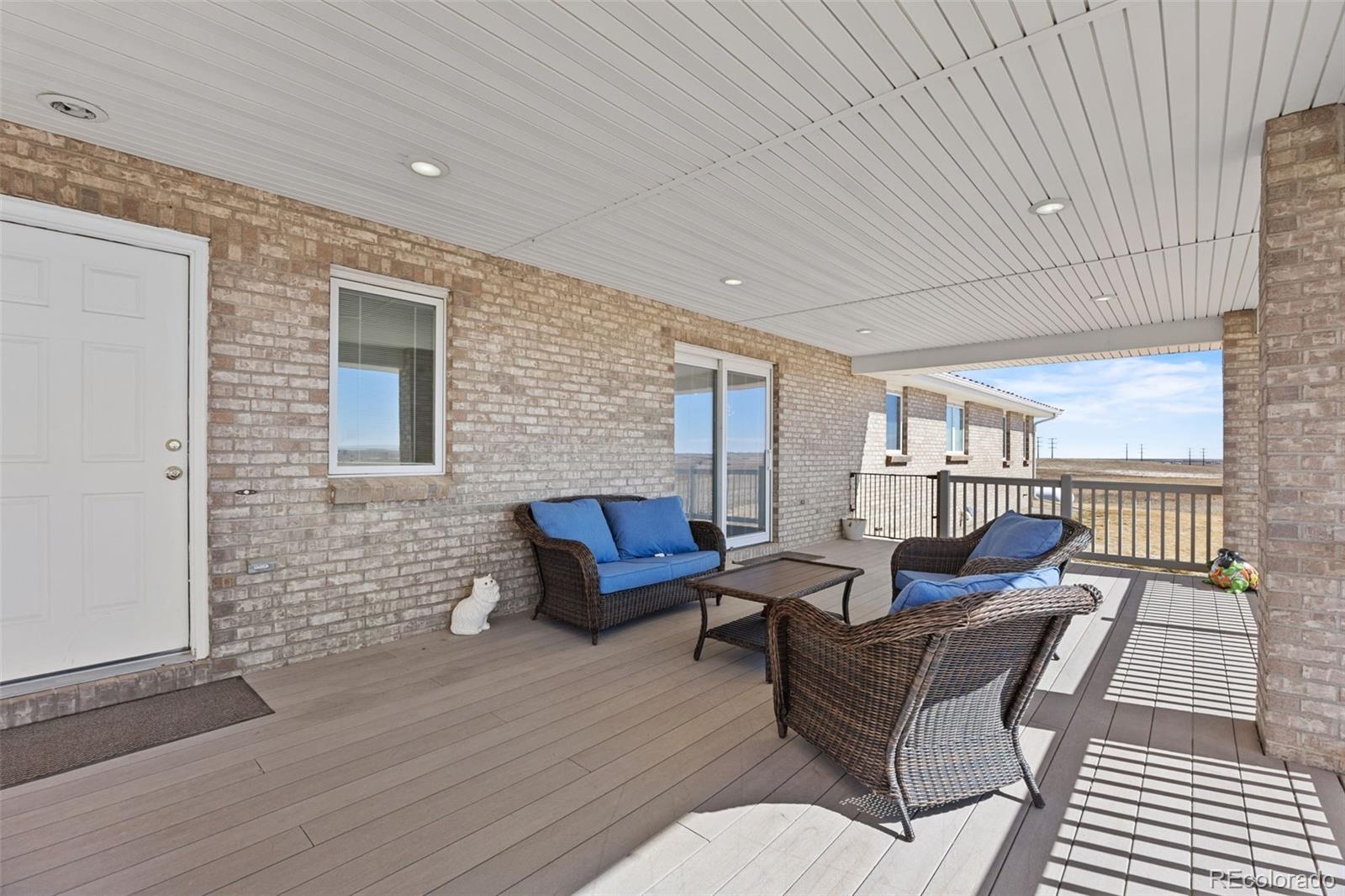 5330 Kiowa-Bennett Road Bennett, CO 80102 - Photo 32 of 50 a outdoor living space with furniture and wooden floor