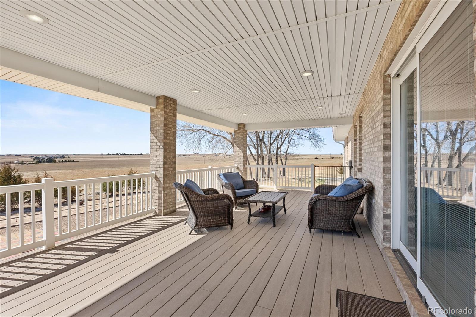 5330 Kiowa-Bennett Road Bennett, CO 80102 - Photo 33 of 50 a balcony with furniture and wooden floor