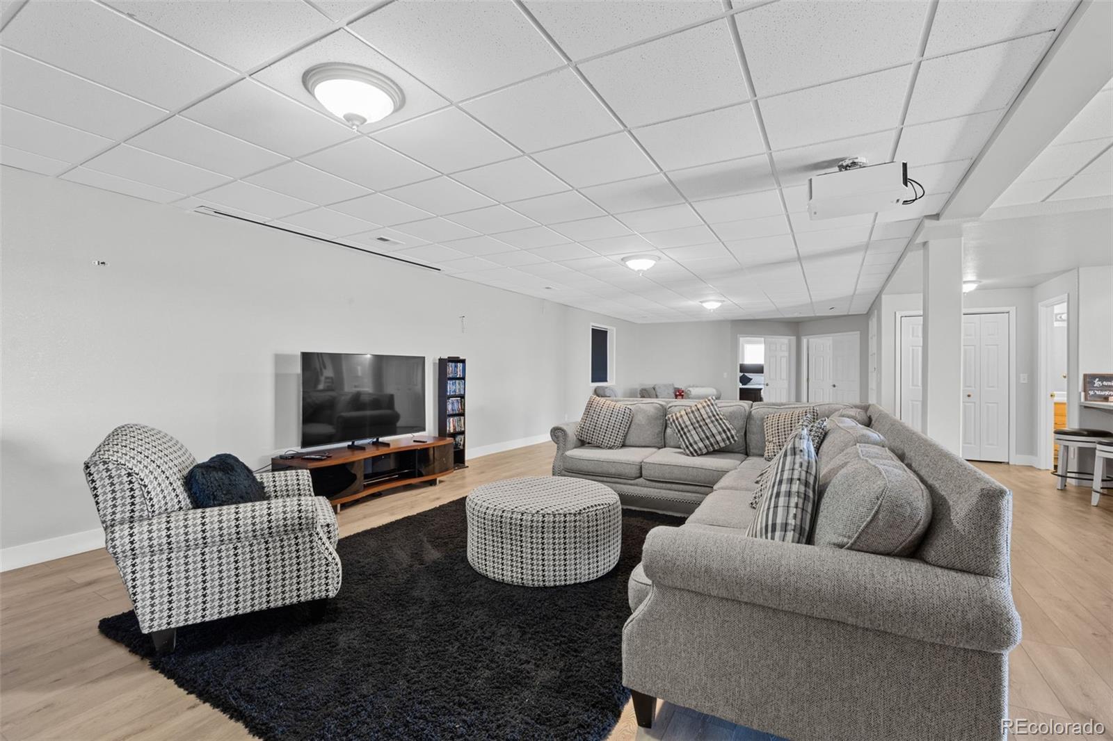5330 Kiowa-Bennett Road Bennett, CO 80102 - Photo 35 of 50 a living room with furniture and a flat screen tv
