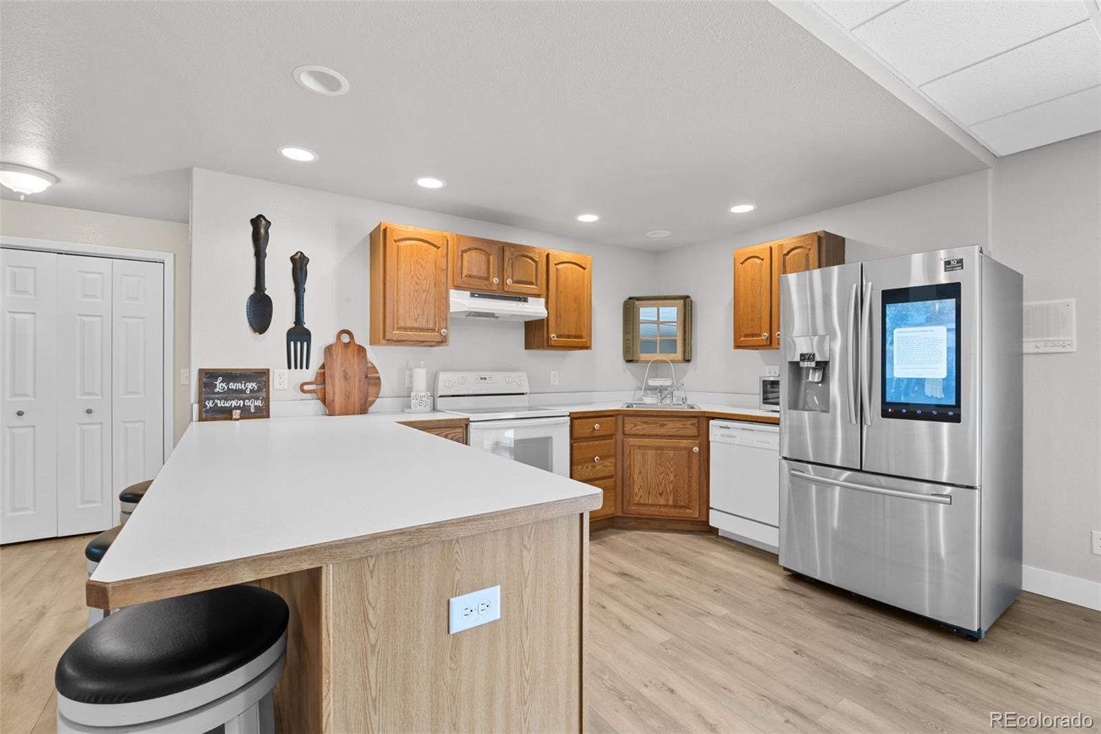5330 Kiowa-Bennett Road Bennett, CO 80102 - Photo 38 of 50 a kitchen with a refrigerator a stove top oven a sink and cabinets