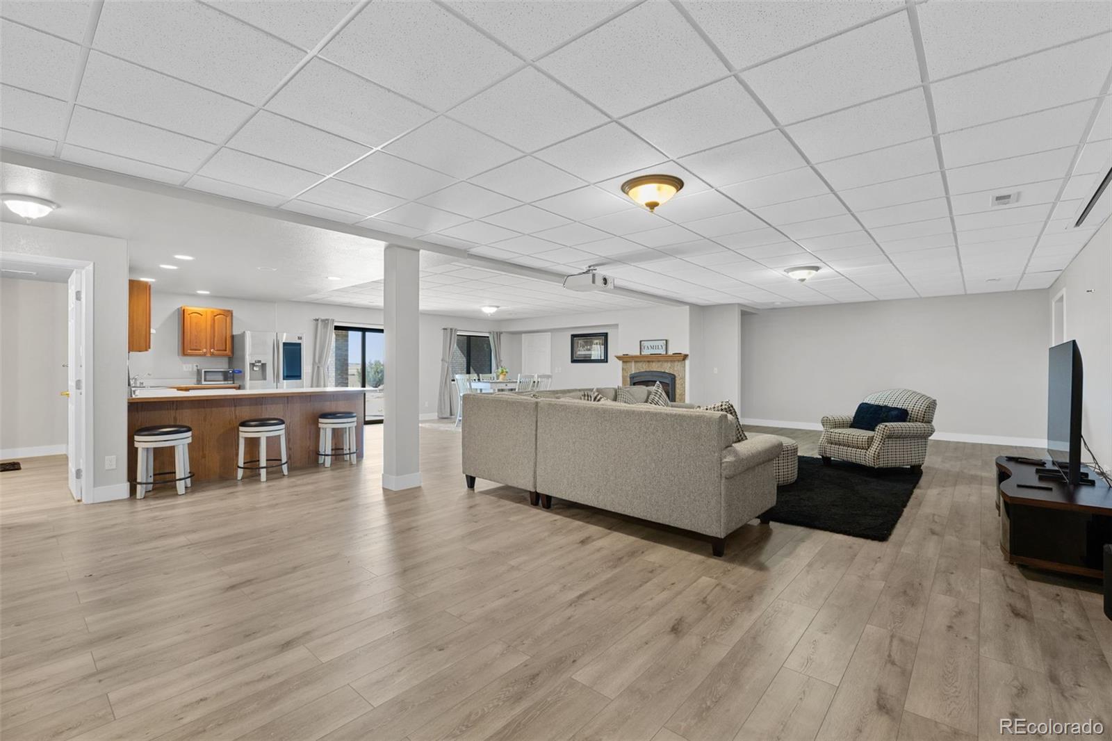 5330 Kiowa-Bennett Road Bennett, CO 80102 - Photo 39 of 50 a living room with furniture and a wooden floor