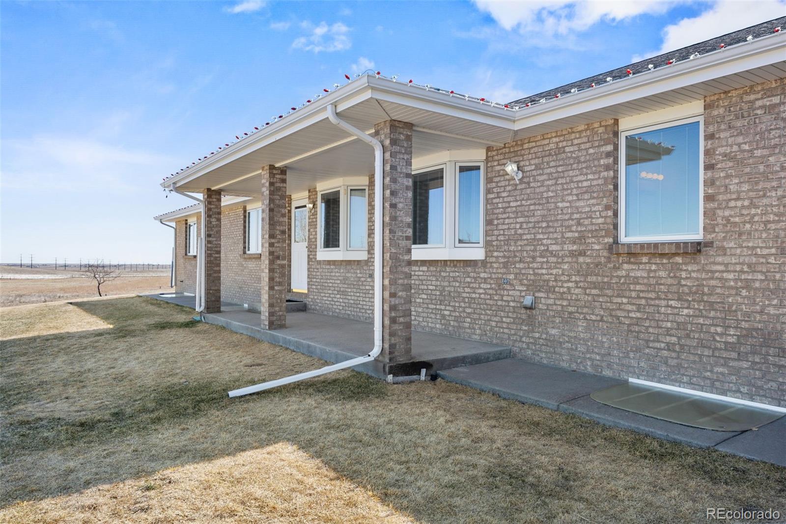 5330 Kiowa-Bennett Road Bennett, CO 80102 - Photo 4 of 50 a front view of a house with a yard