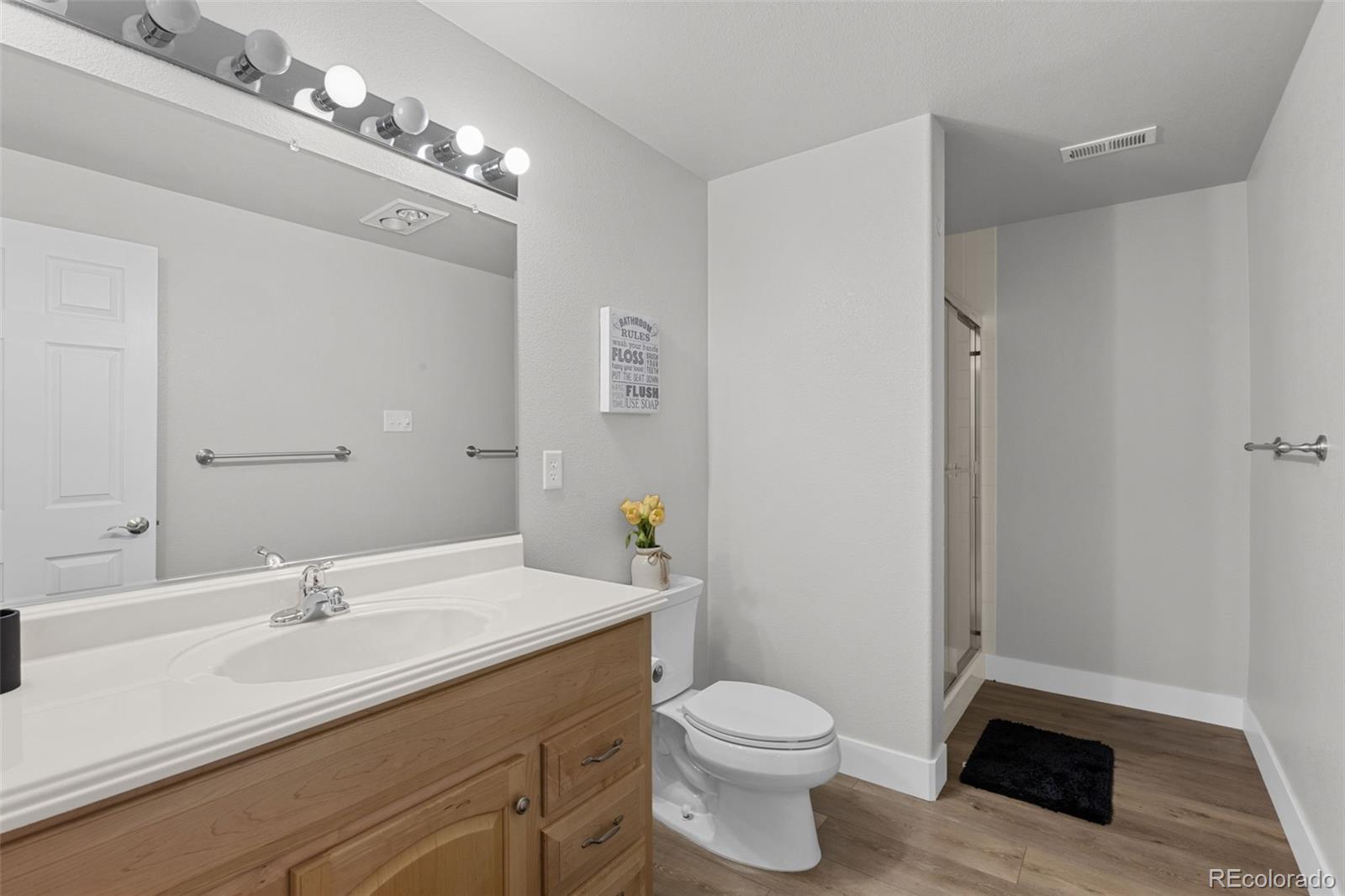 5330 Kiowa-Bennett Road Bennett, CO 80102 - Photo 41 of 50 a bathroom with a sink a toilet and a mirror