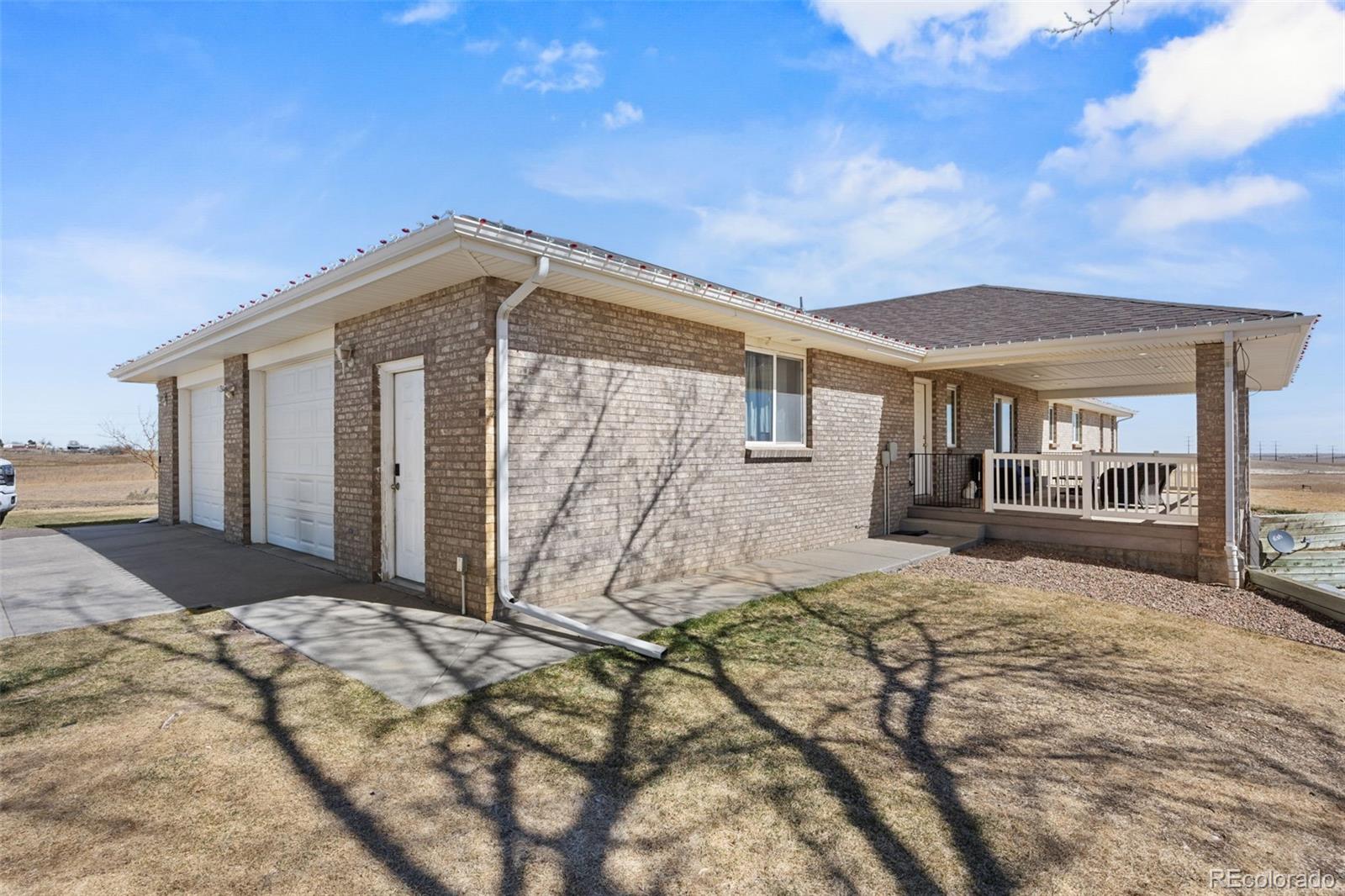 5330 Kiowa-Bennett Road Bennett, CO 80102 - Photo 6 of 50 a front view of a house with a yard