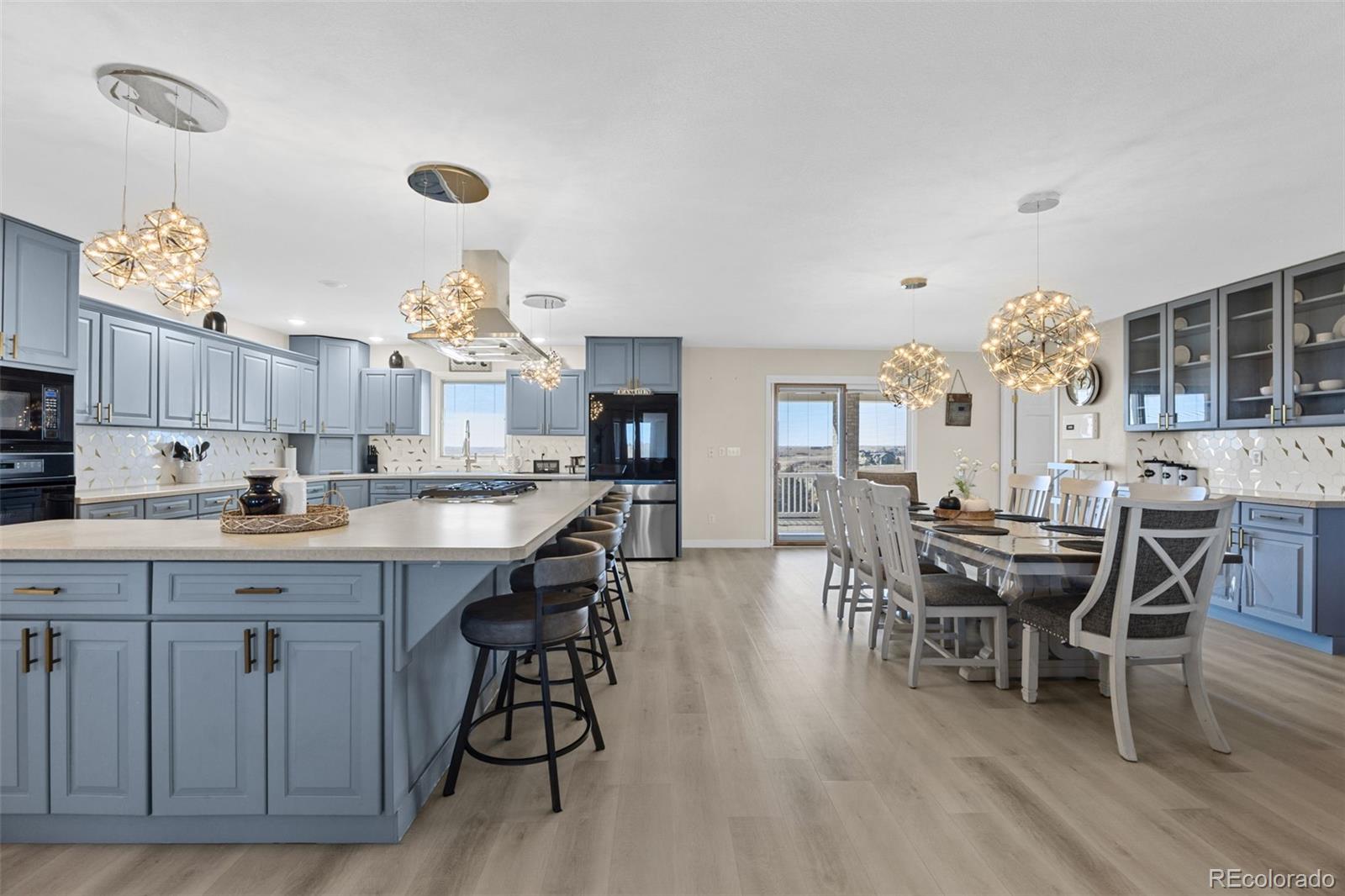 5330 Kiowa-Bennett Road Bennett, CO 80102 - Photo 10 of 50 a large kitchen with cabinets wooden floor and stainless steel appliances
