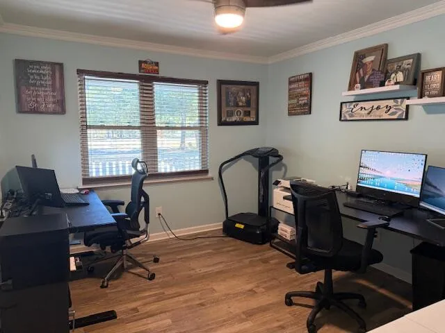 a view of a workspace with furniture and a window