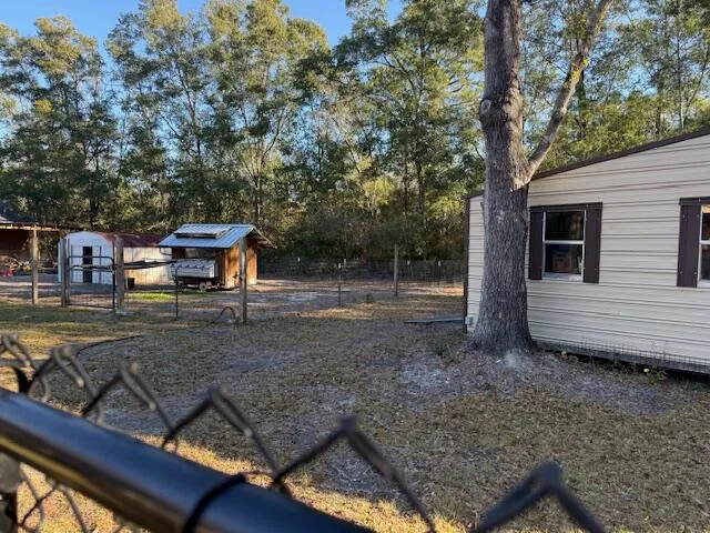 a view of a wooden deck and a yard