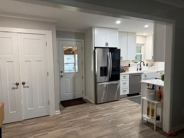a kitchen with a refrigerator a sink and dishwasher