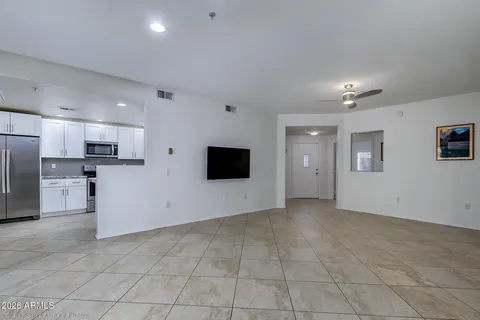 a view of an empty room with a kitchen