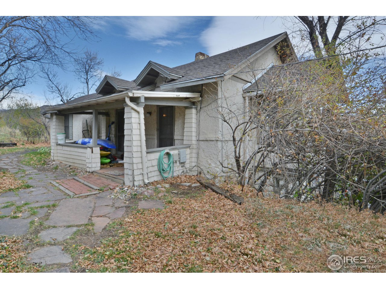 1590 Hillside Road Boulder, CO 80302 - Photo 1 of 25 a view of a white house with large windows and a small yard