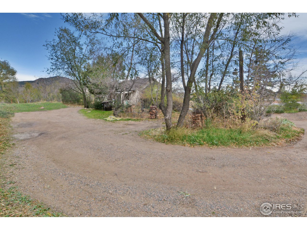 1590 Hillside Road Boulder, CO 80302 - Photo 7 of 25 a view of a dirt road with a building in the background
