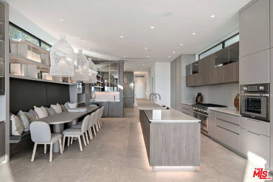 938-940 Palisades Beach Road Santa Monica, CA 90403 - Photo 56 of 72 a kitchen with stainless steel appliances kitchen island granite countertop a sink and a refrigerator