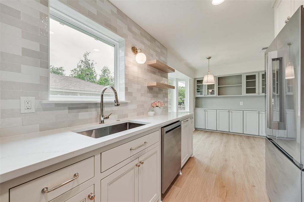 13427 Purple Sage Road Dallas, TX 75240 - Photo 12 of 31 a kitchen with a sink and cabinets