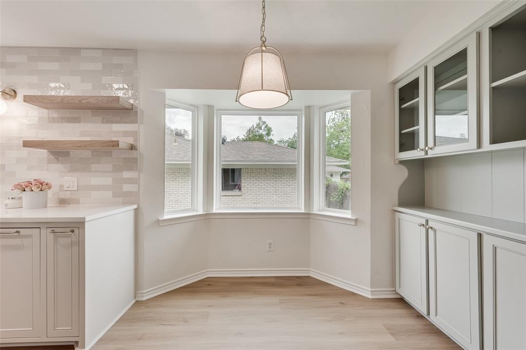 13427 Purple Sage Road Dallas, TX 75240 - Photo 14 of 31 This space features light-toned flooring, a bay window with three panes, and a hanging light fixture