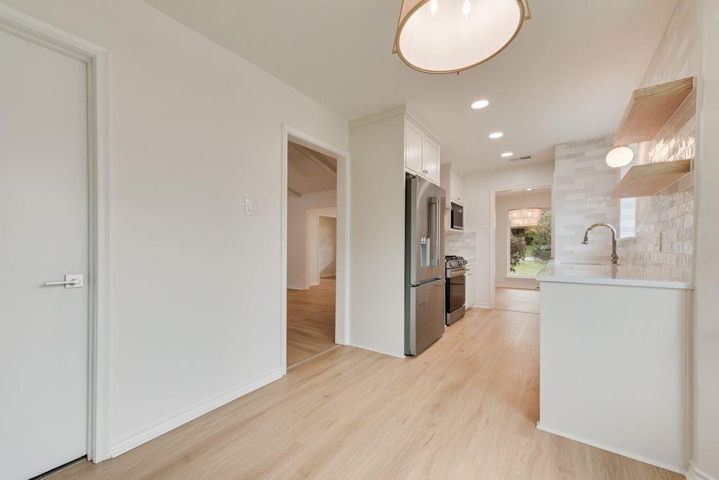 13427 Purple Sage Road Dallas, TX 75240 - Photo 15 of 31 Clean finishes and neutral tones create a kitchen that feels both modern and warm.