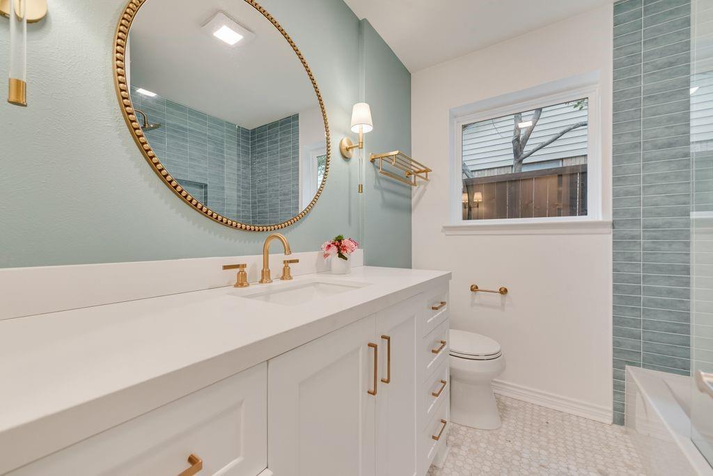 13427 Purple Sage Road Dallas, TX 75240 - Photo 16 of 31 a bathroom with a toilet sink and mirror