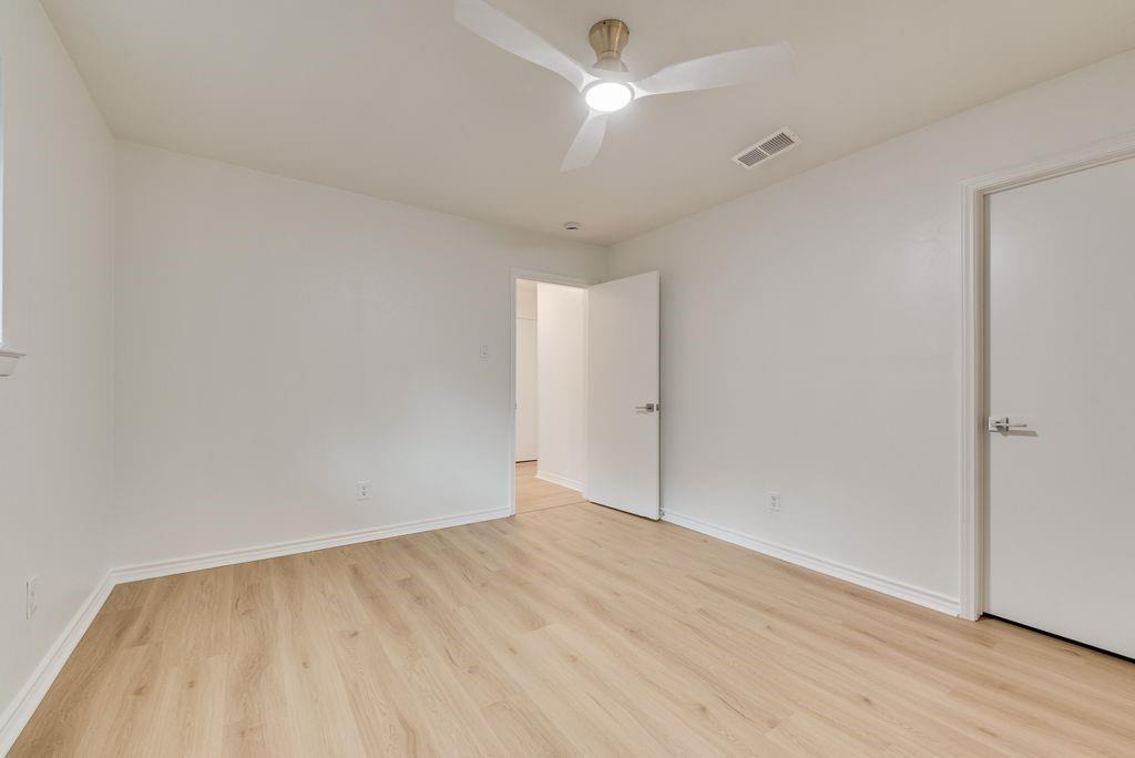 13427 Purple Sage Road Dallas, TX 75240 - Photo 18 of 31 Soft natural light and updated flooring make this bedroom feel calm and comfortable.