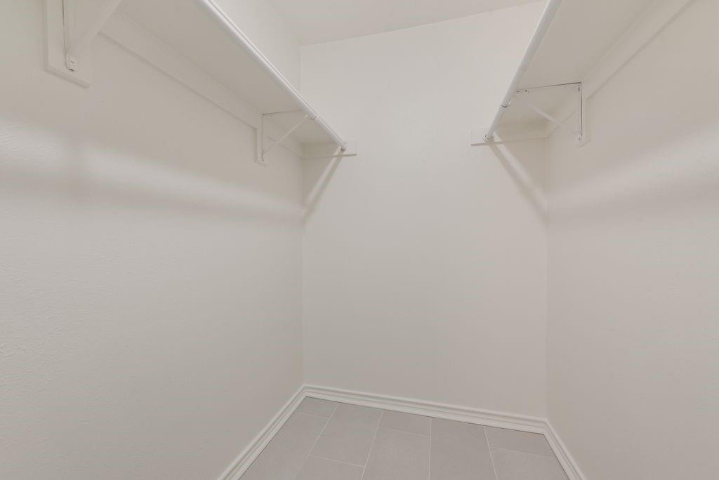 13427 Purple Sage Road Dallas, TX 75240 - Photo 22 of 31 Built-in shelving in the walk-in closet provides organized storage while keeping the space clean and simple.