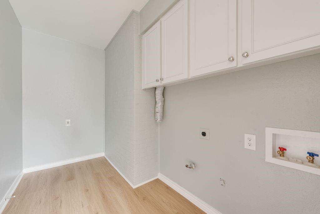13427 Purple Sage Road Dallas, TX 75240 - Photo 26 of 31 A dedicated laundry space adds convenience while keeping daily tasks tucked away.
