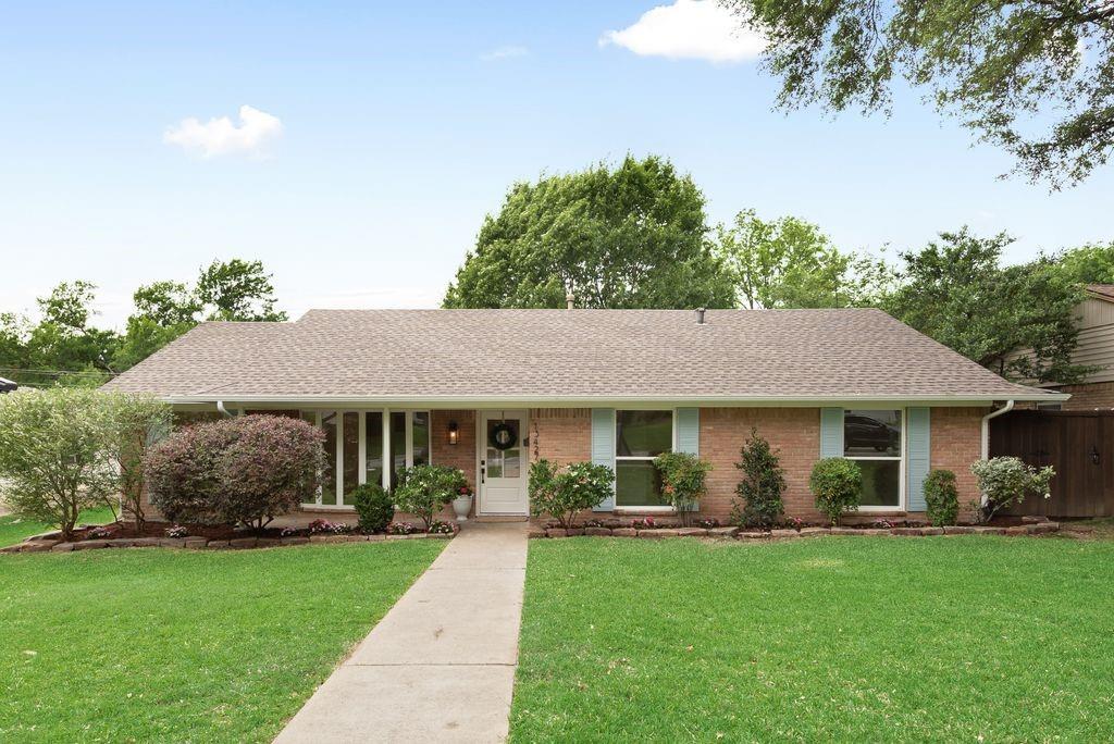 13427 Purple Sage Road Dallas, TX 75240 - Photo 28 of 31 A classic brick façade paired with well-maintained lawn and mature trees creates a warm, welcoming first impression.