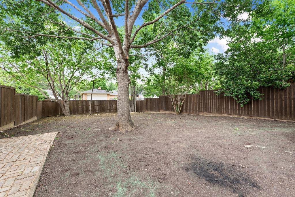 13427 Purple Sage Road Dallas, TX 75240 - Photo 29 of 31 Mature trees and wood fencing create a private outdoor setting with room to enjoy.