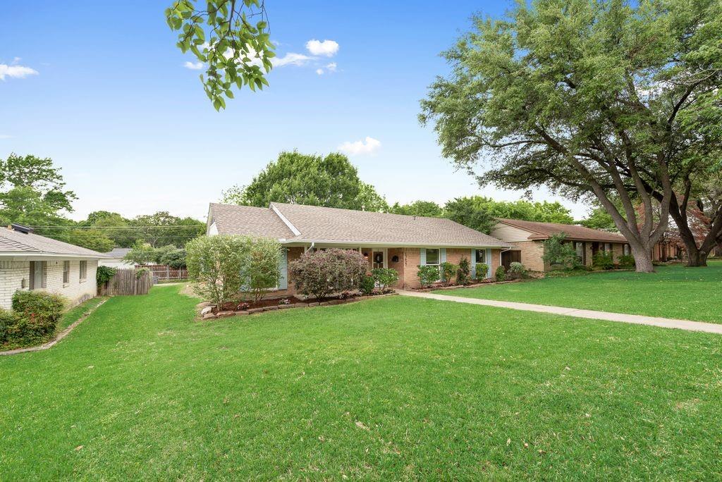 13427 Purple Sage Road Dallas, TX 75240 - Photo 30 of 31 a front view of a house with a yard and trees