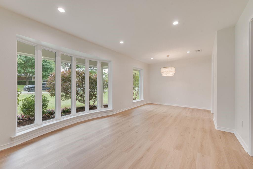 13427 Purple Sage Road Dallas, TX 75240 - Photo 3 of 31 a view of an empty room with wooden floor and a window