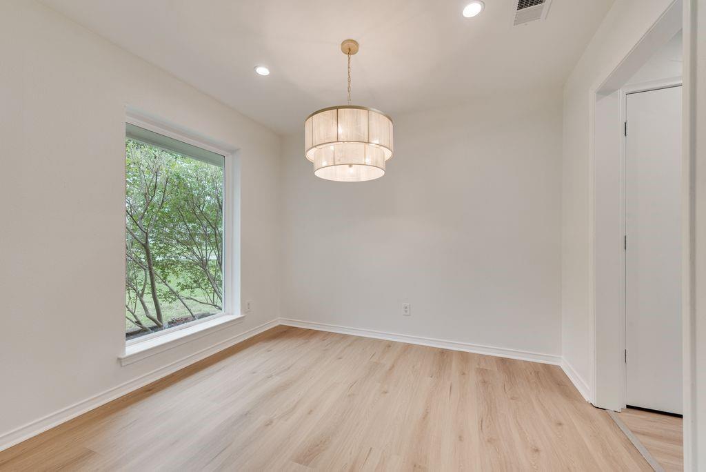 13427 Purple Sage Road Dallas, TX 75240 - Photo 4 of 31 A softly defined space with designer lighting offers flexibility for dining or additional living.